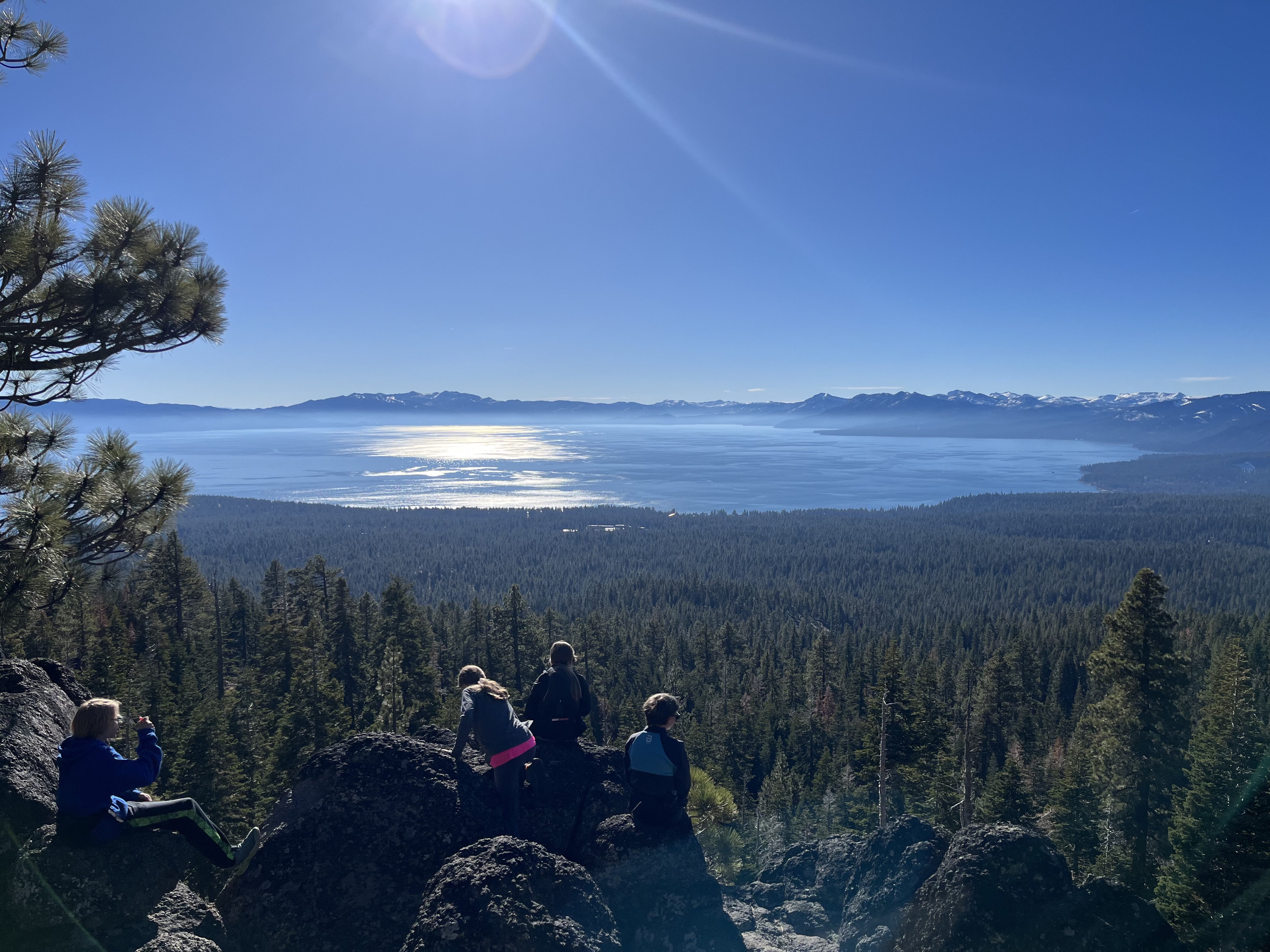 kids sitting on rock looking over Lake Tahoe