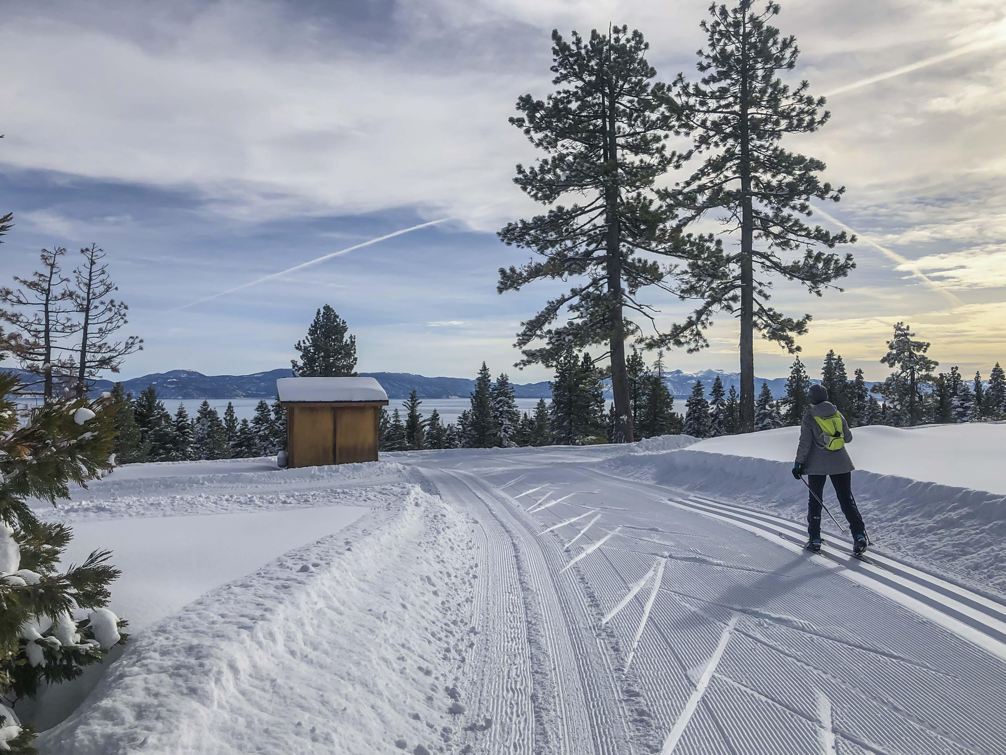 Cross-country skier on Silver Trail with view of Lake Tahoe