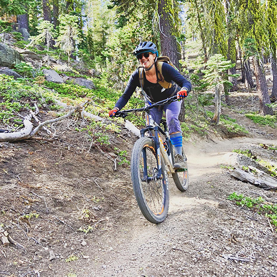 Woman mountain biking on single track in Tahoe